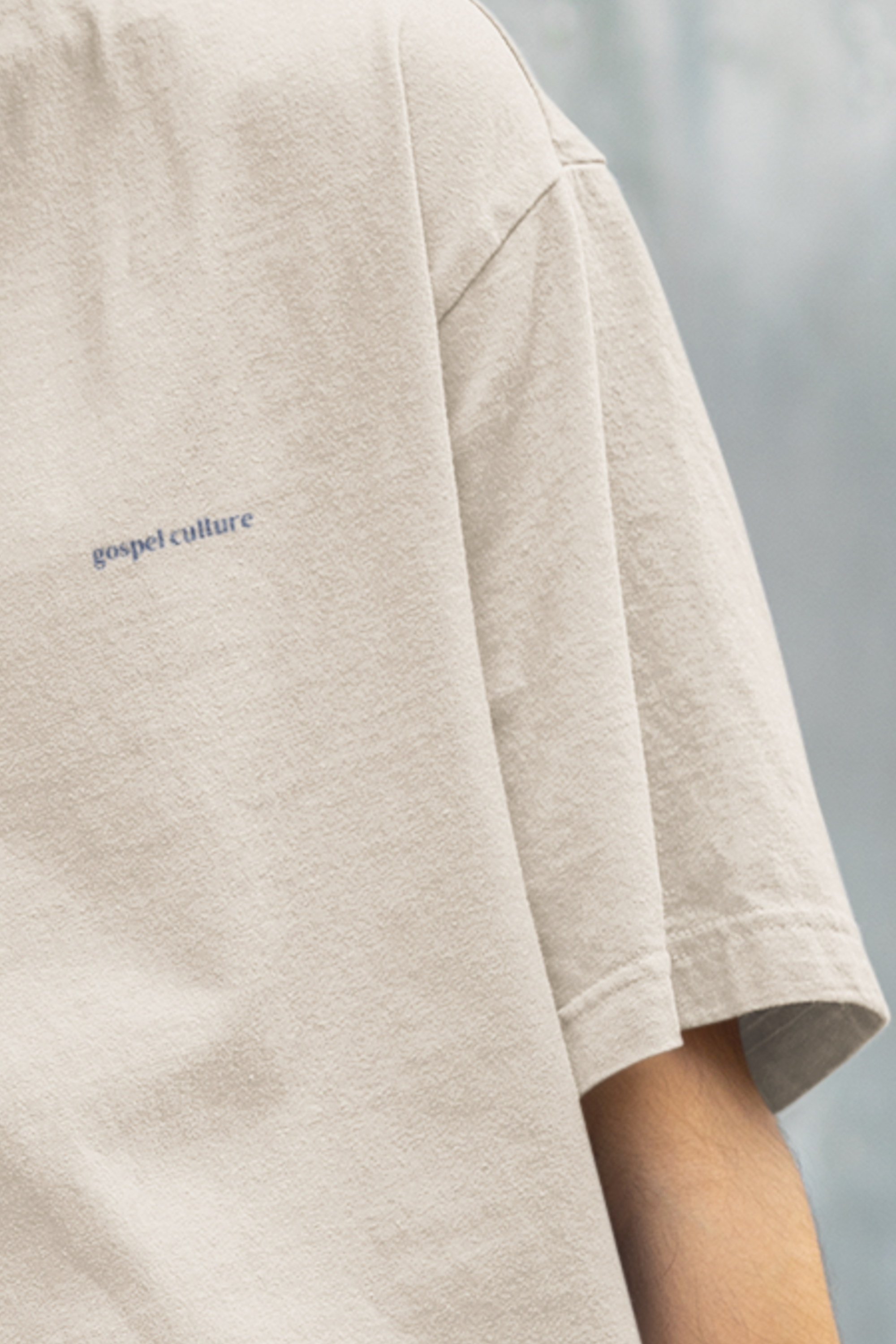Beige t-shirt with 'gospel culture' text on a blurred background