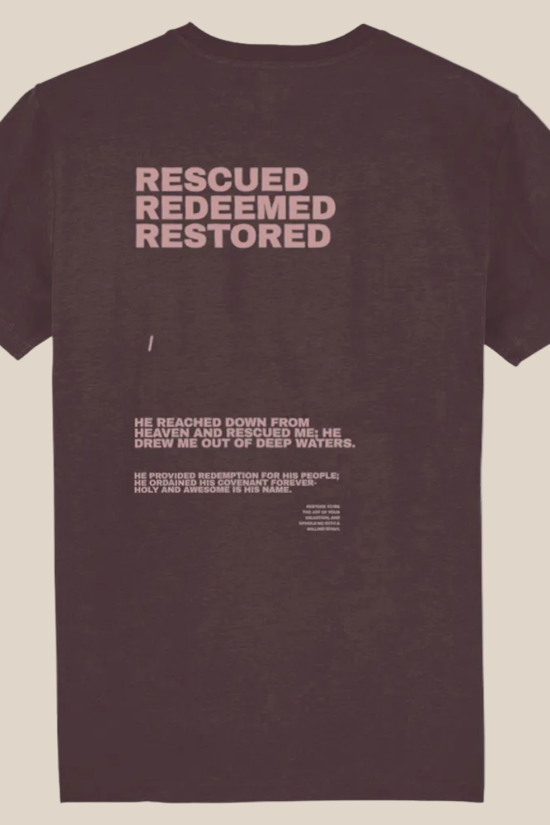 rescued redeemed restored text on back of brown t shirt