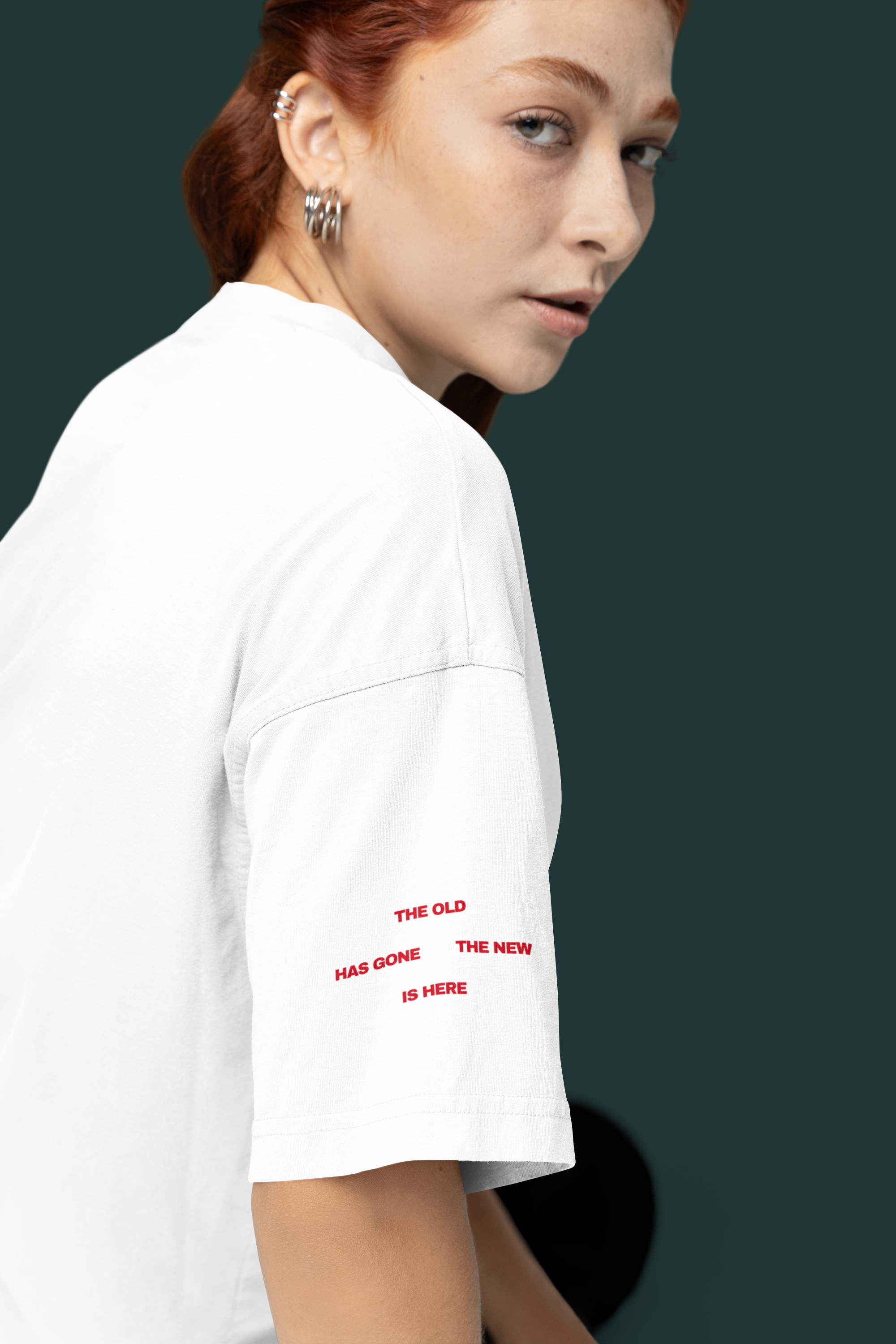 Person wearing a Christian white t-shirt with red text on a dark background
